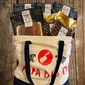 Papa Did It tote bag with beef prosciutto, pork loin, basturma, turkey balyk, and beef sticks arranged in a holiday gift set