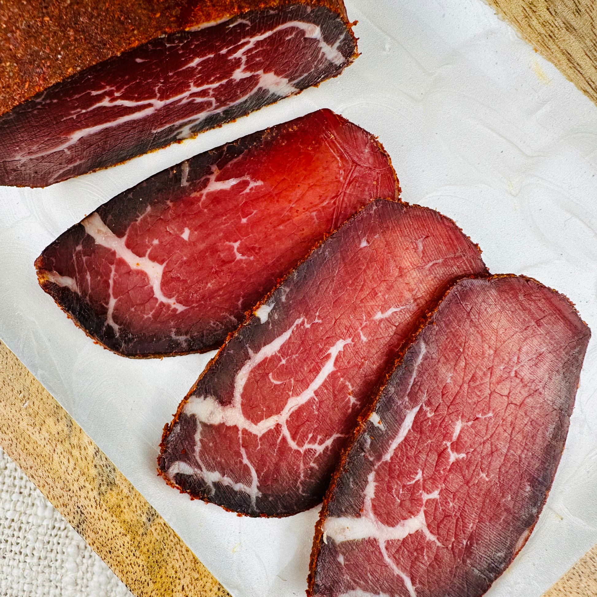 Sliced basturma air-dried beef on cutting board – Papa Did It