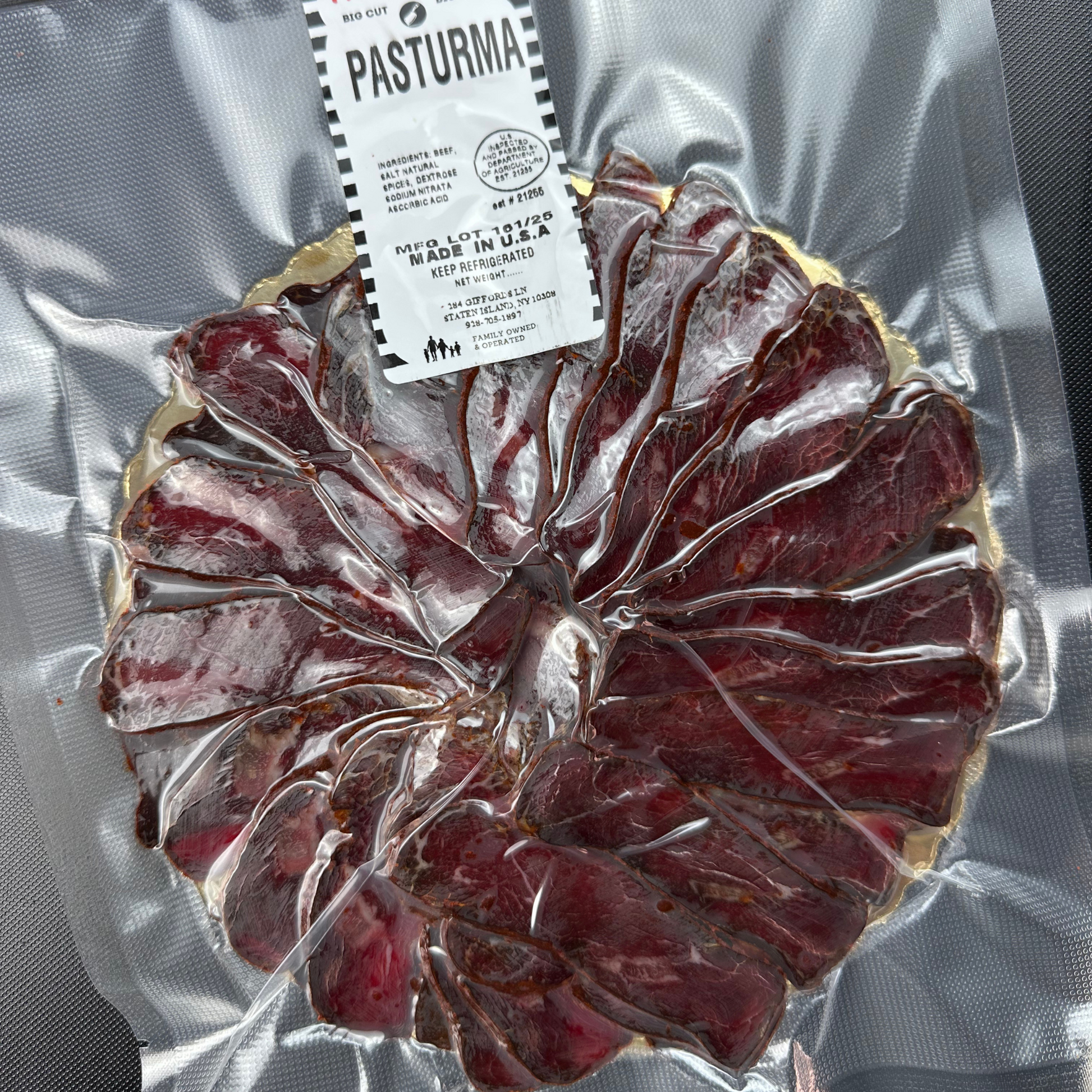 Vacuum-sealed package of sliced basturma with label showing ingredients and branding.