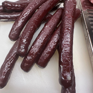 Side view of sliced smoked beef sticks showing interior texture