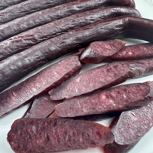 Close view of the glossy smoked surface of beef sticks