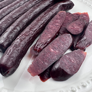 Full plate of whole and sliced beef sticks for serving