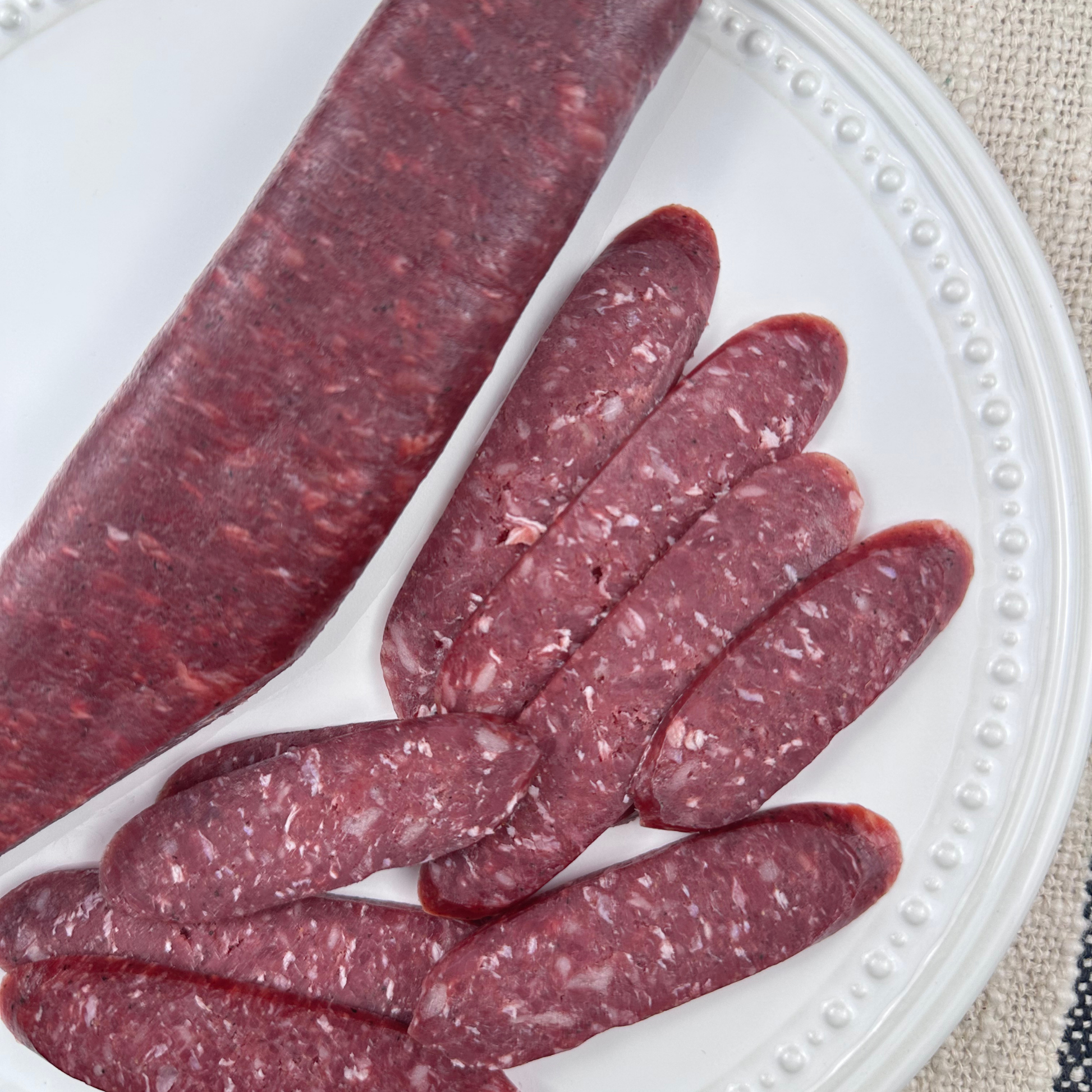 Close-up view of cured beef sudjuk slices