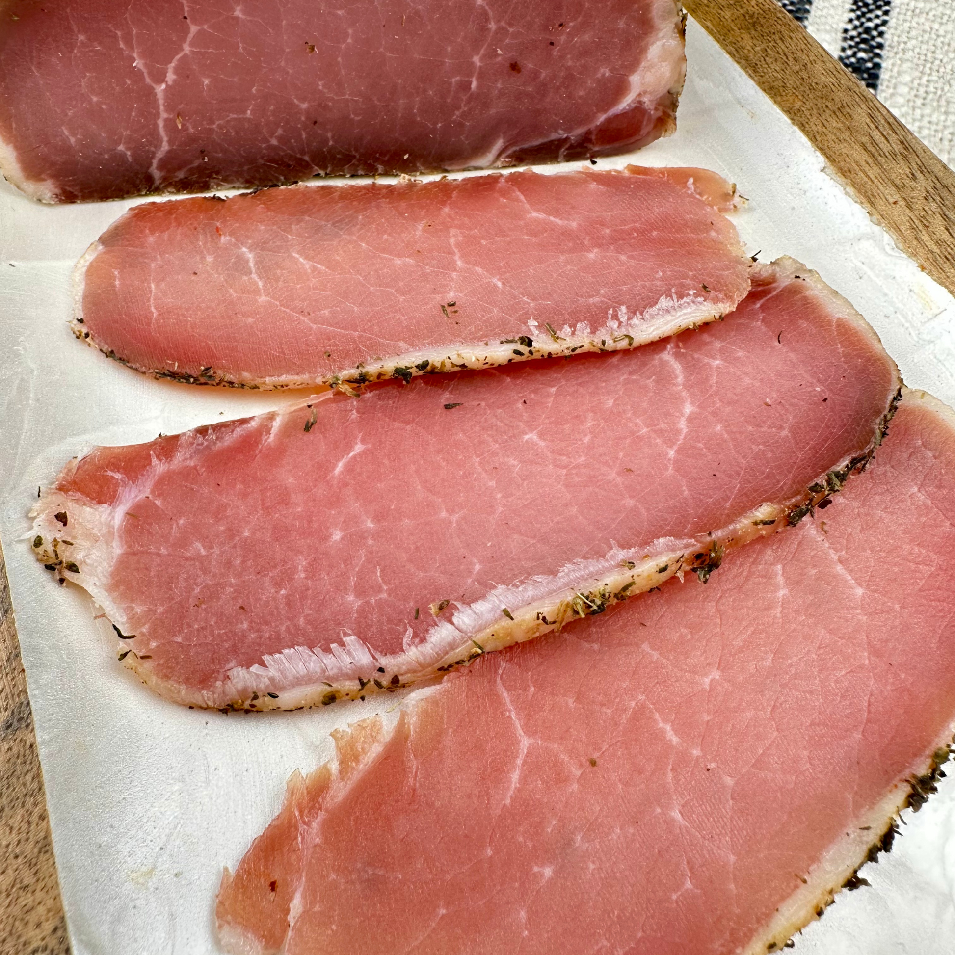 Dry pork loin with herbs — thinly sliced, cured, and seasoned with aromatic spices