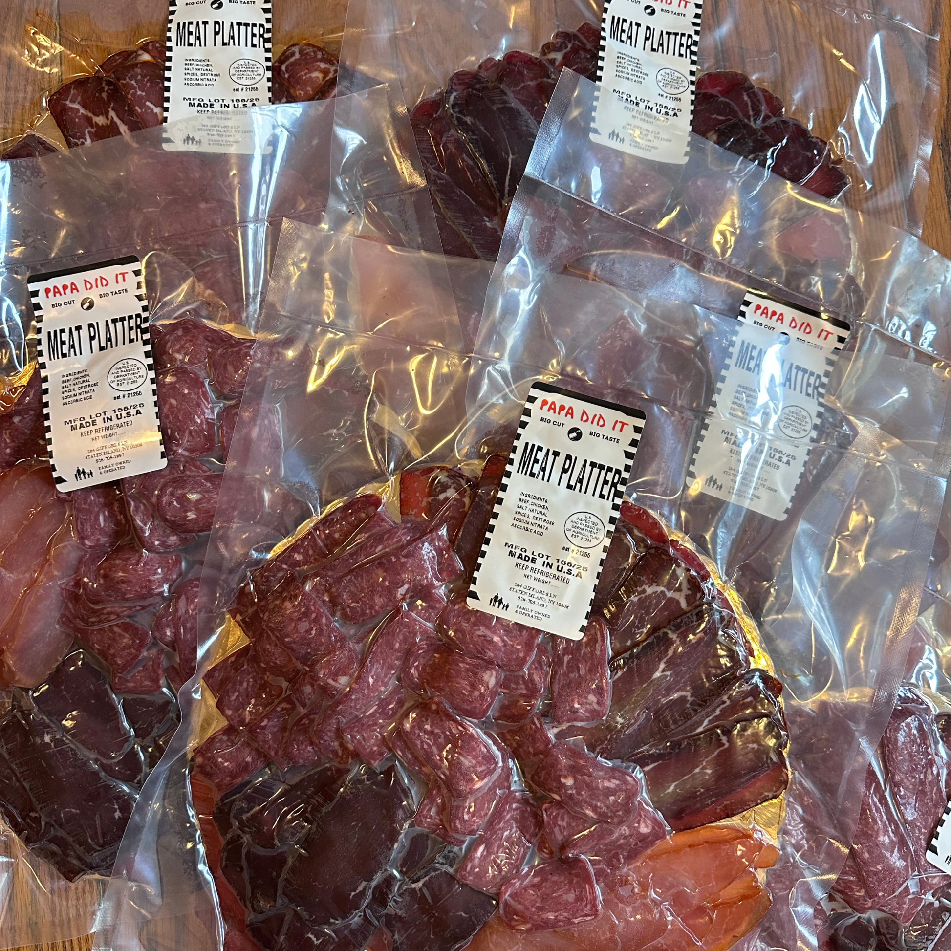 Vacuum-sealed packs of Papa Did It. Meat Platter — showcasing assorted smoked meats neatly arranged for freshness and easy transport