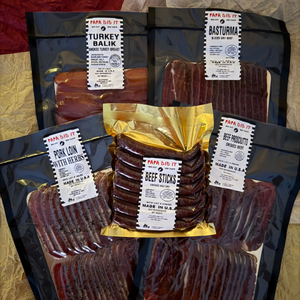 Holiday charcuterie board made with Papa Did It hickory-smoked meats — basturma, beef prosciutto, turkey balyk, and beef sticks served with cheese, nuts, and crackers.