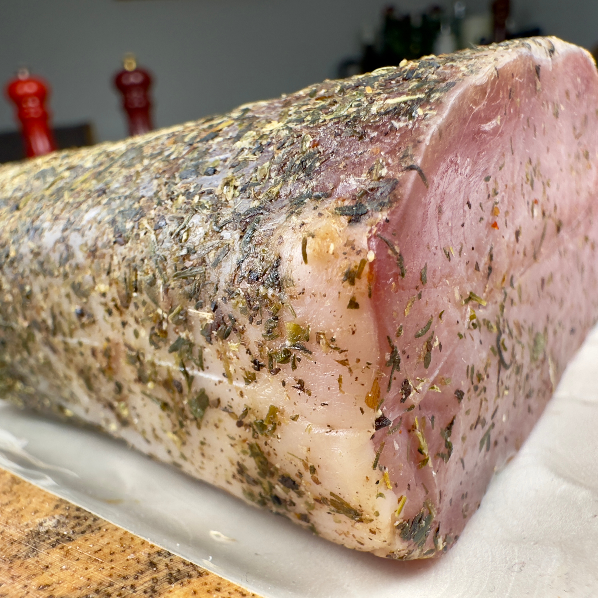 Side view of pork loin with herb crust showing tender crosscut