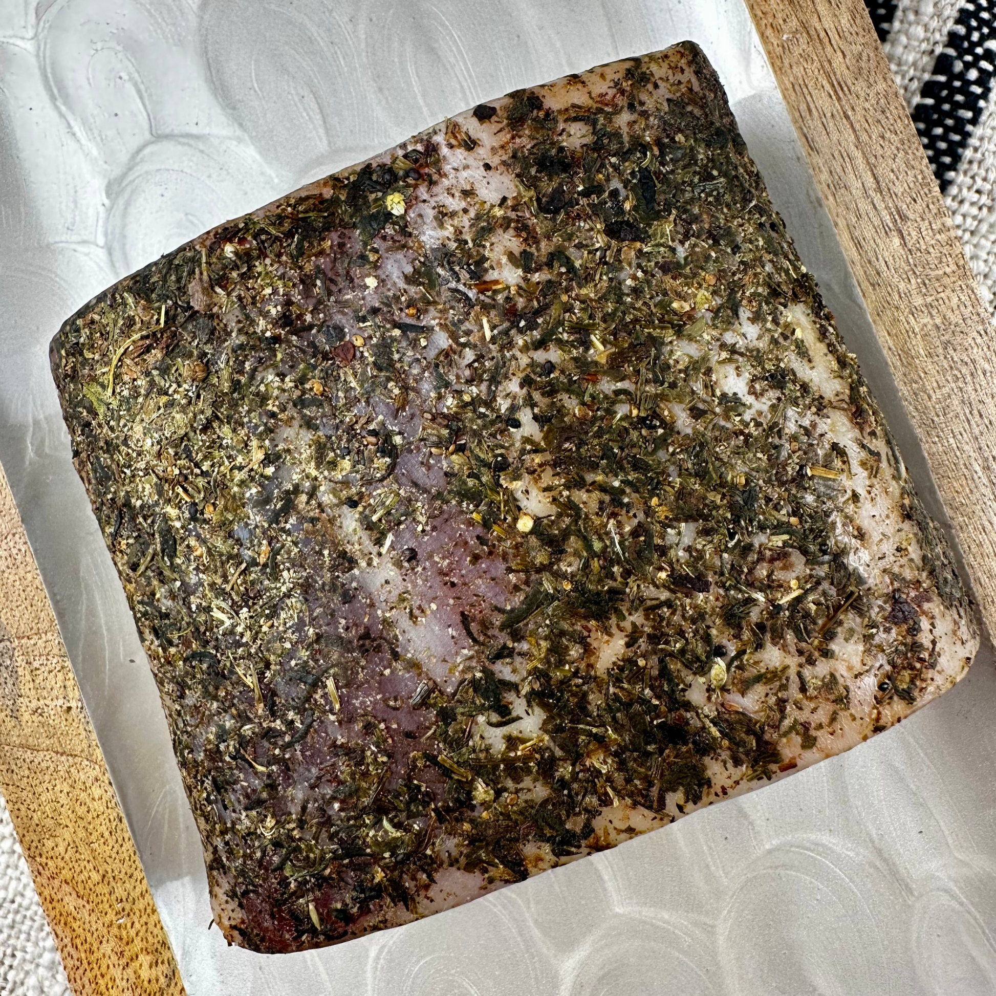 Flat cut of pork loin with visible herb seasoning on all sides